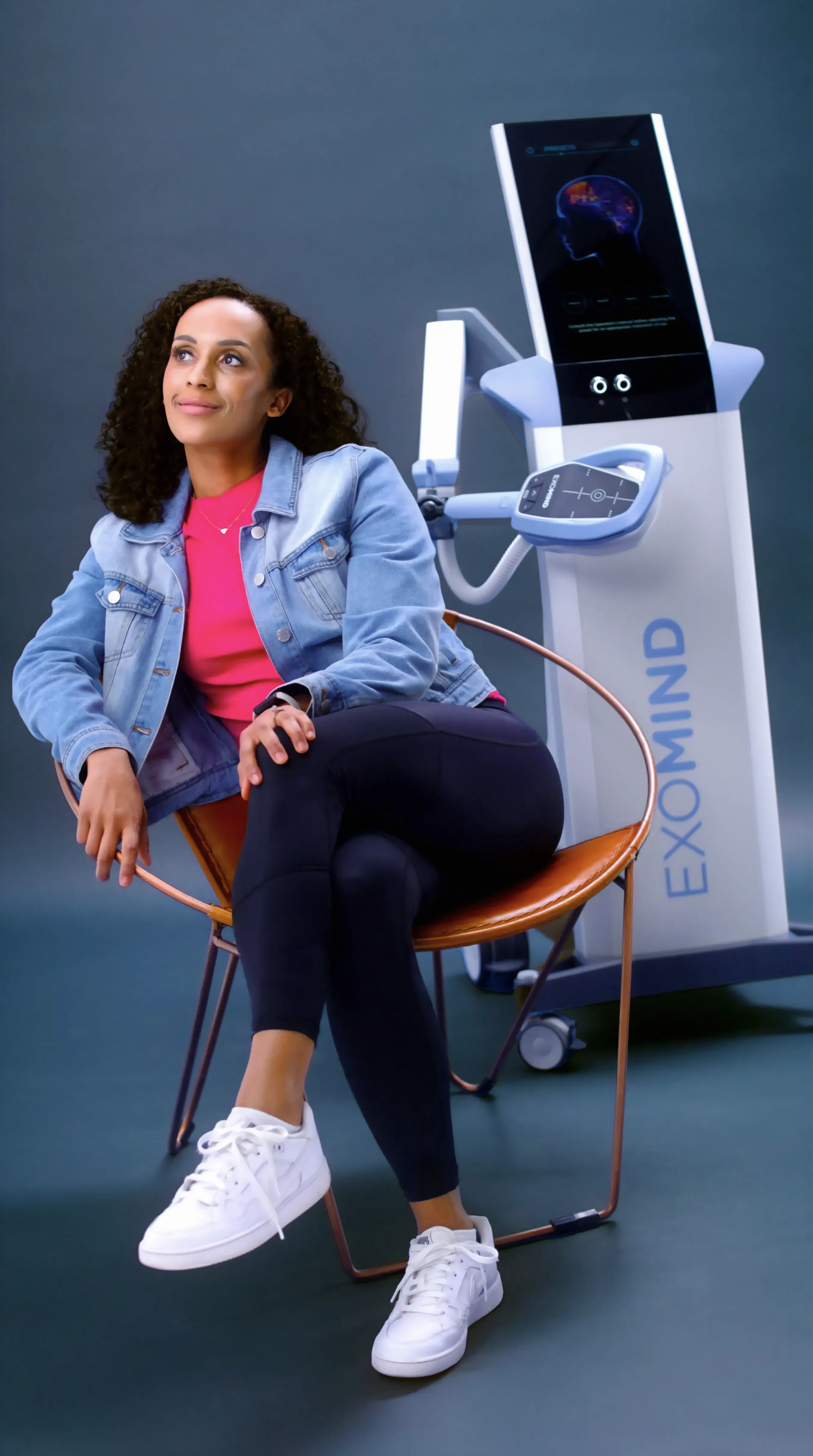 Patient seated in a treatment chair during an Exomind brain stimulation session in Naples, Florida