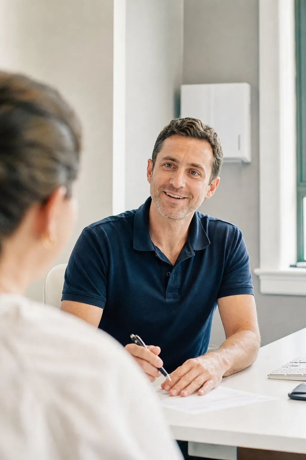 Chiropractor explaining rear-end crash forces on the spine during an auto accident injury consultation
