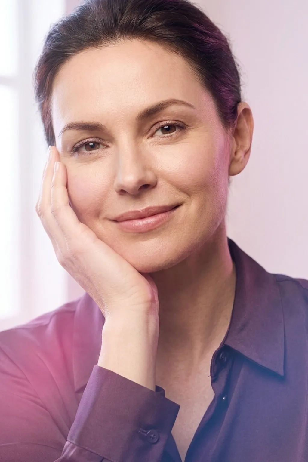 A nurse practitioner assessing facial skin texture in the treatment room at Applegate MedSpa, Covington KY