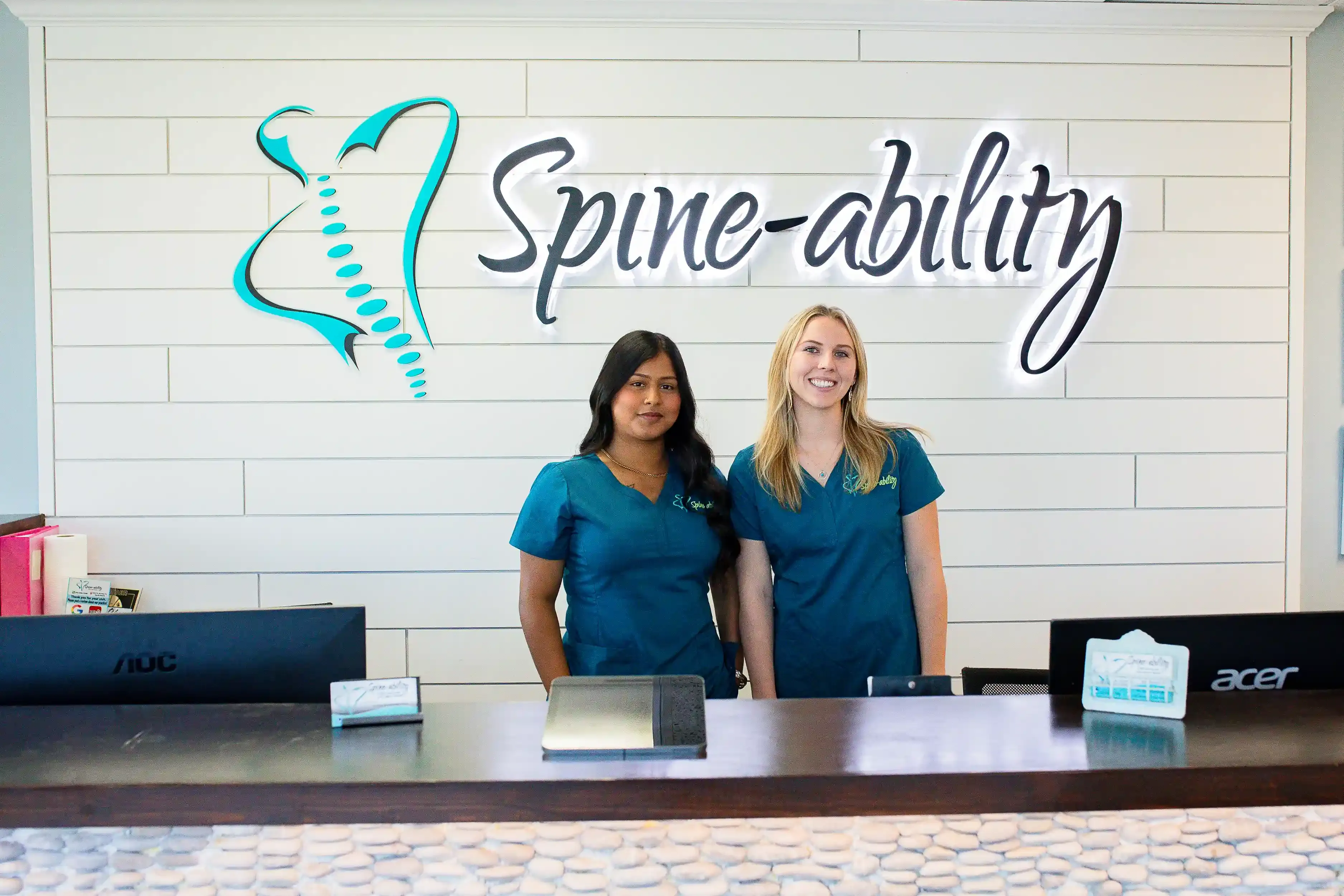 Dr. David and Dr. Marissa Fetherman outside Spine-Ability Apollo Beach office