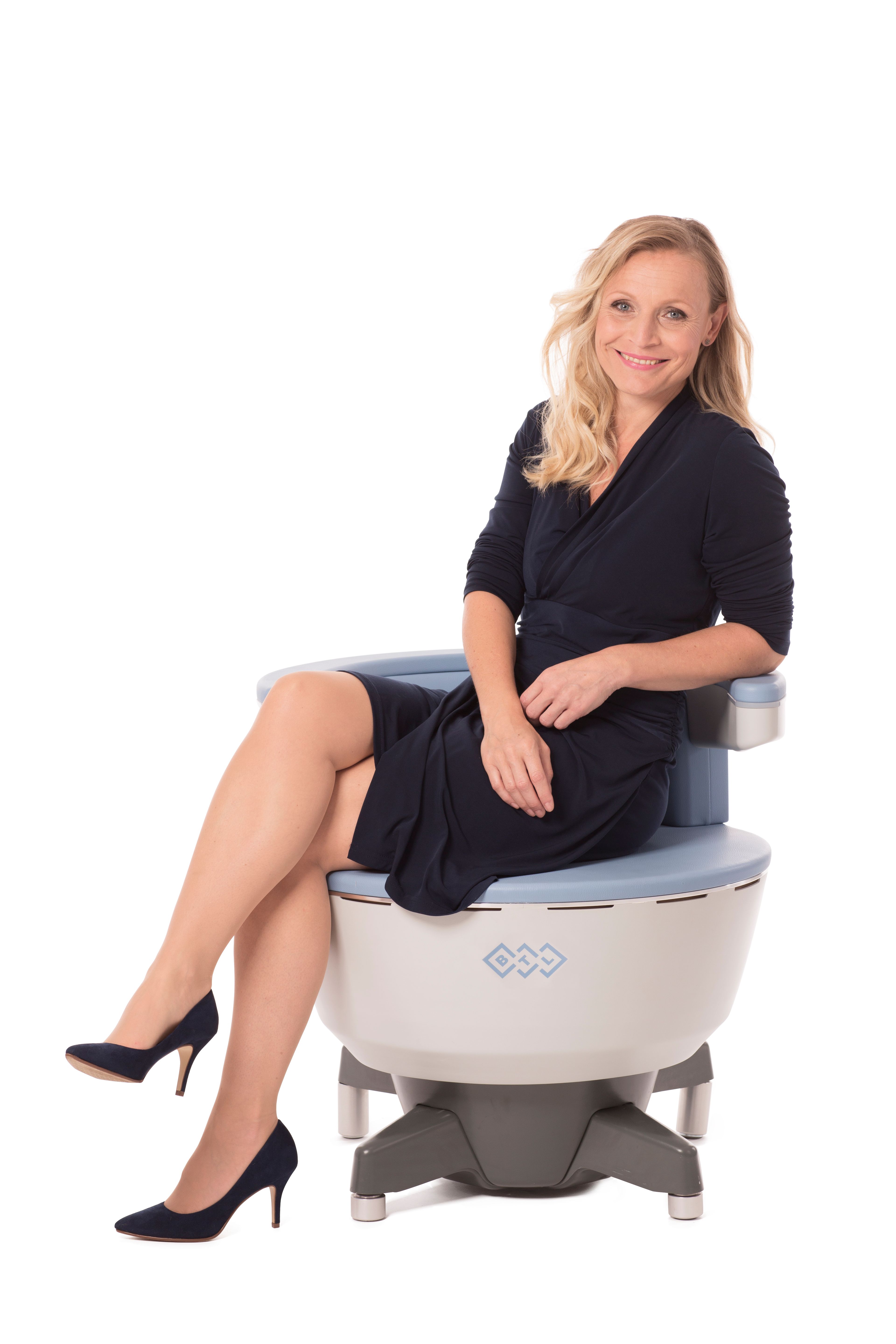 Patient consulting with provider about Emsella pelvic floor therapy benefits