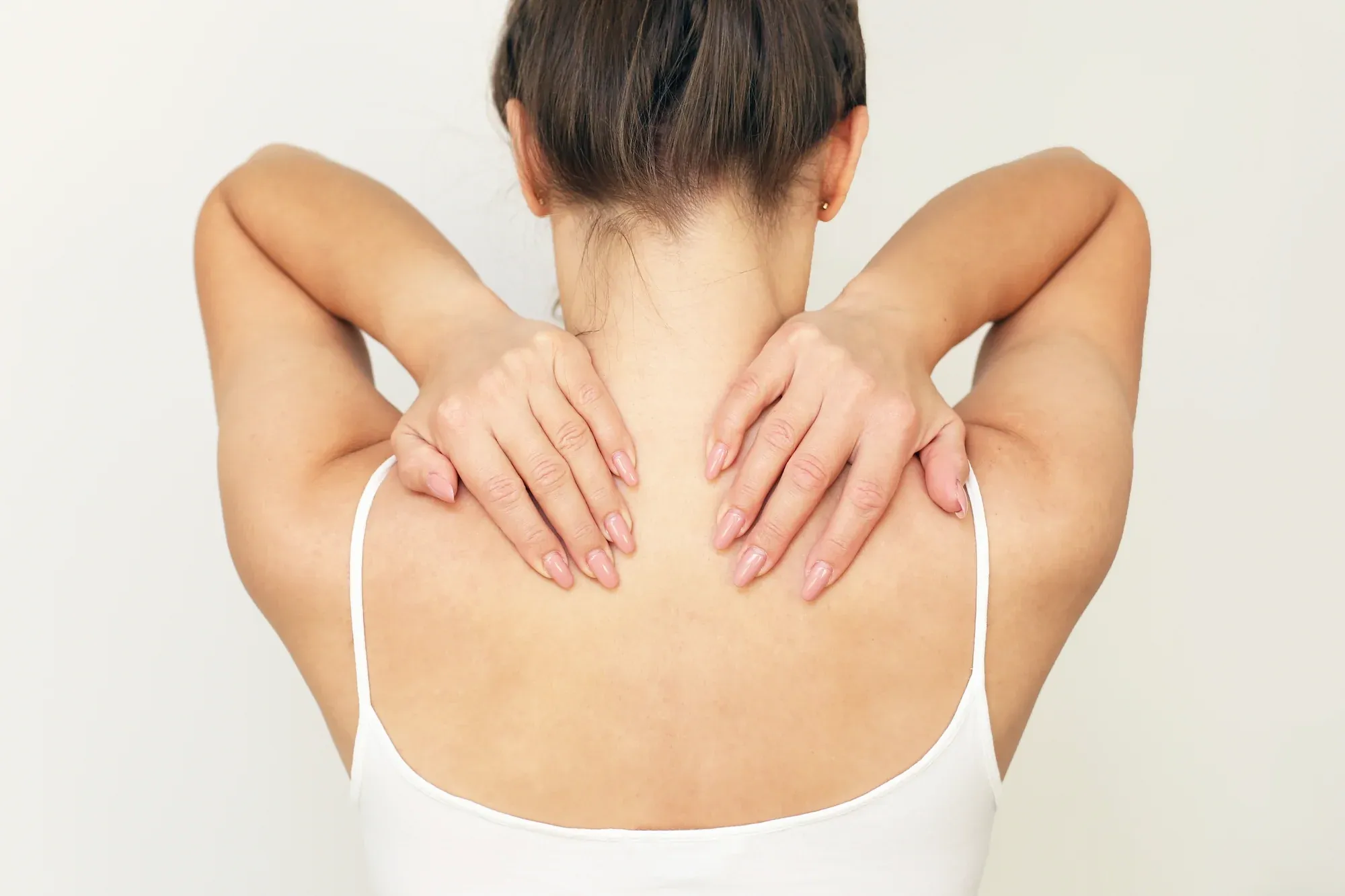 Tampa adult evaluating midsection in mirror at ProActive Chiropractic