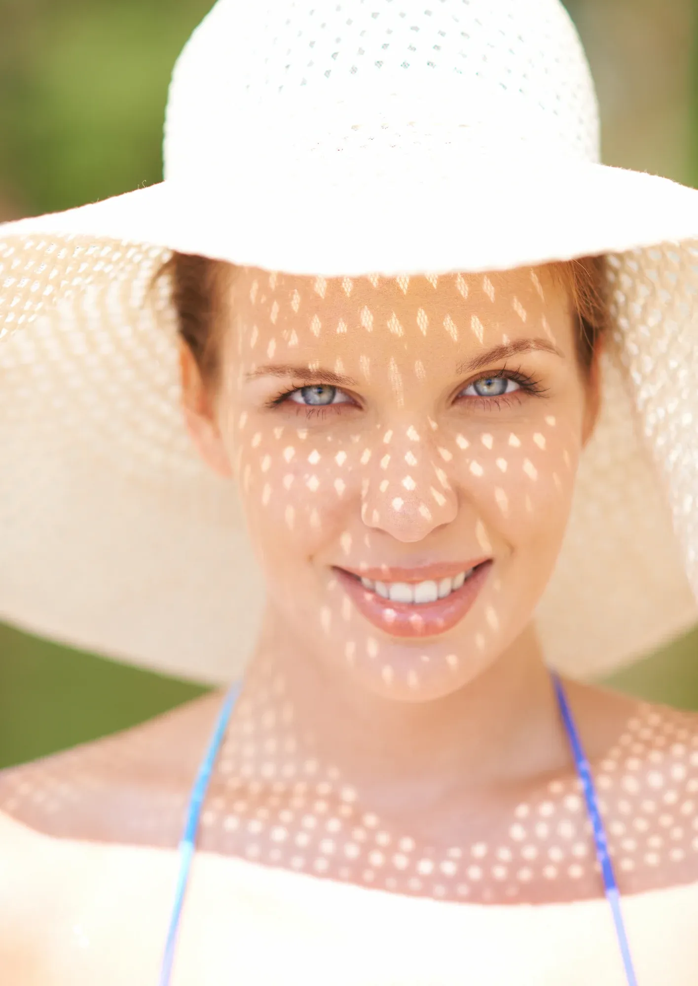 Person concerned about sun damage examining skin at Resurgent Health Fargo