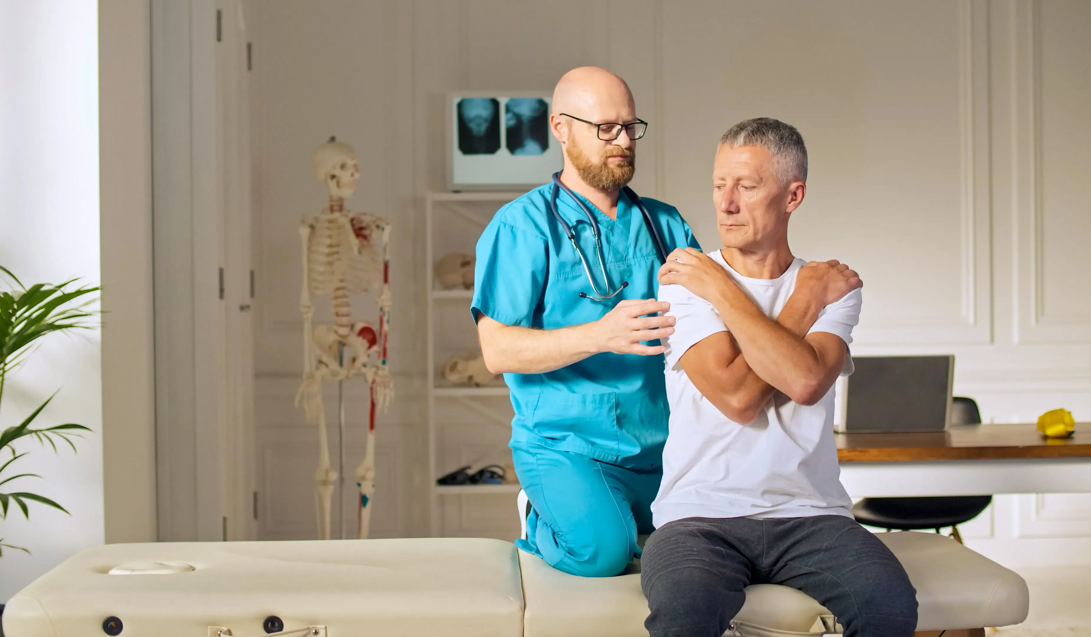 Dr. Leo Chen reviewing imaging with a patient at Emerald Coast Sports Medicine and Orthopaedics in Fort Walton Beach, FL