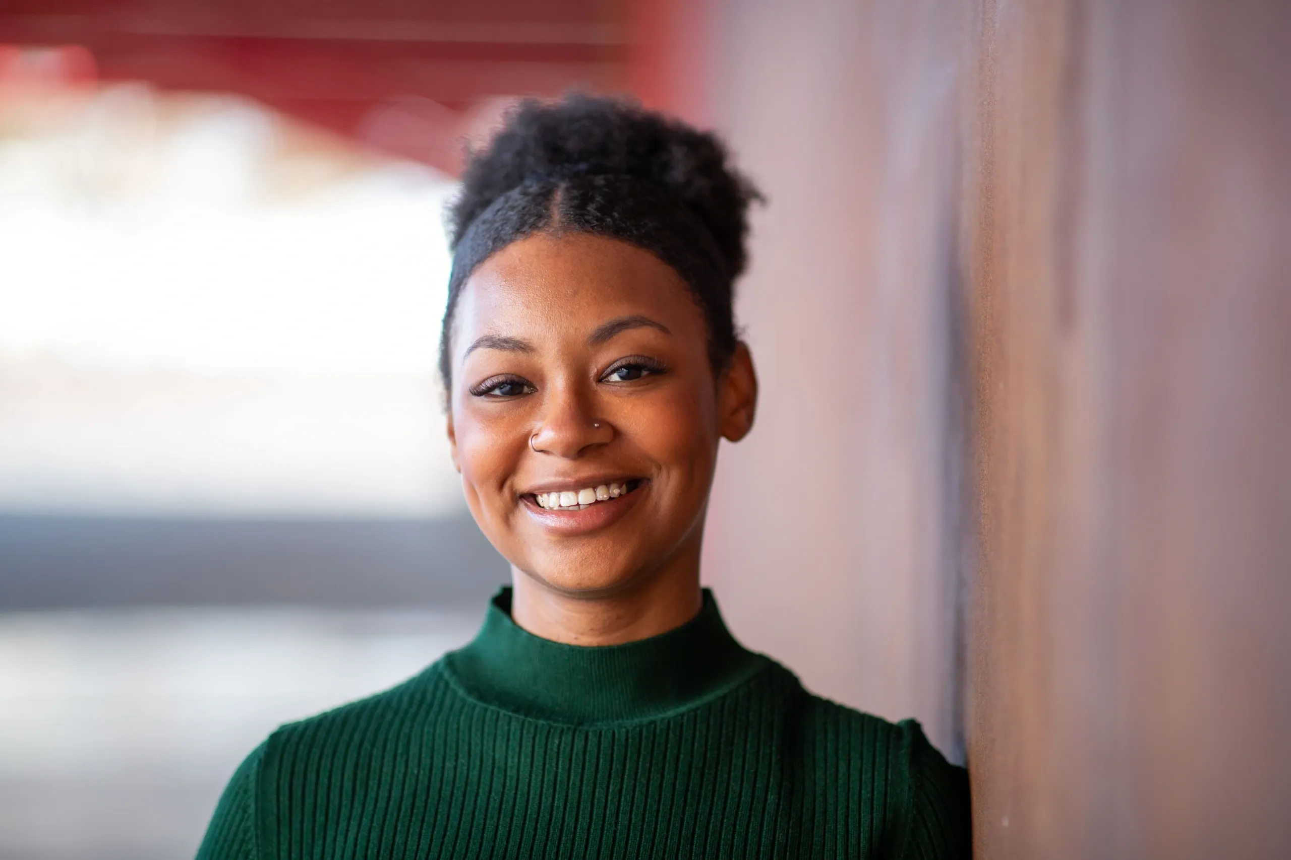 Smiling woman with radiant healthy skin representing Anu Aesthetics face mind and body services in Elizabethtown