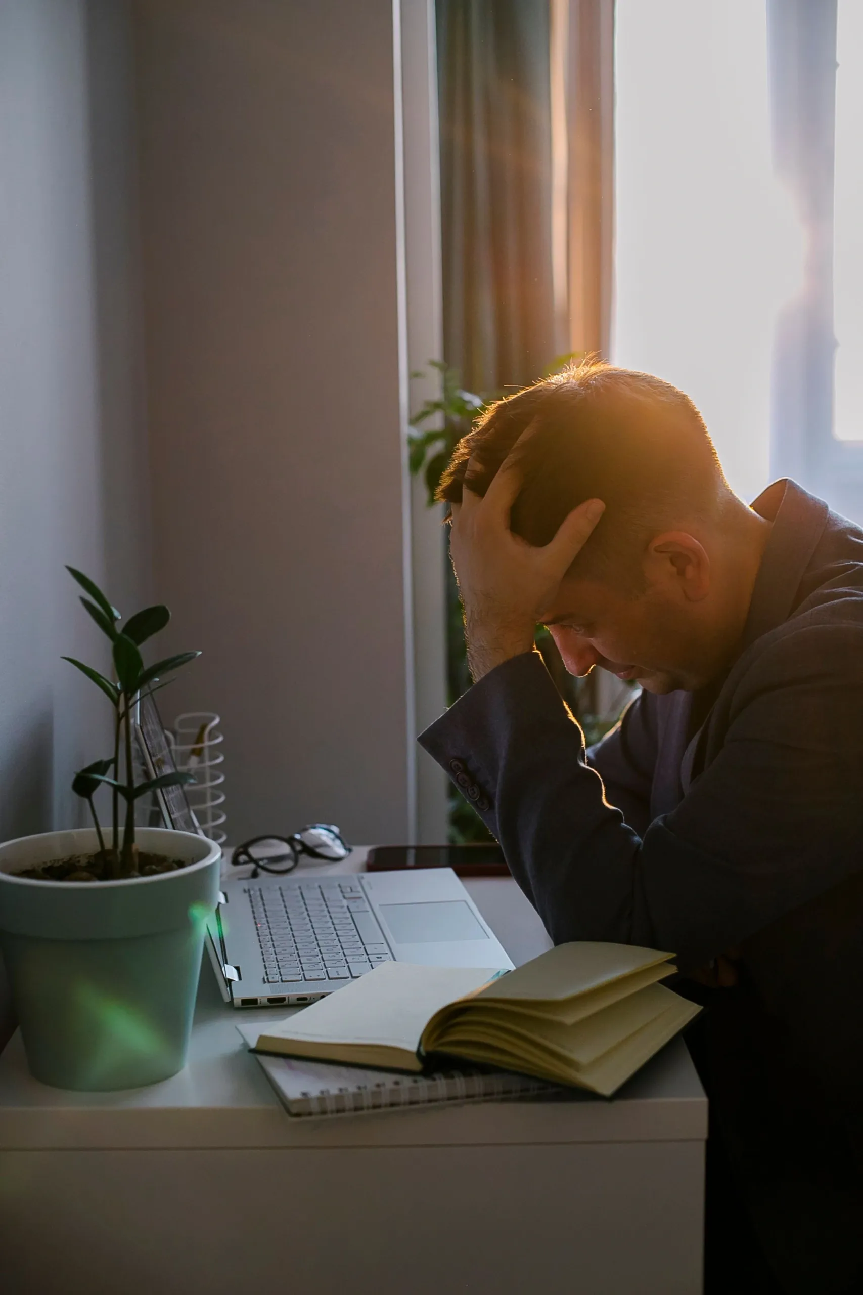 Woman looking distracted while working from home experiencing brain fog symptoms in Fargo ND