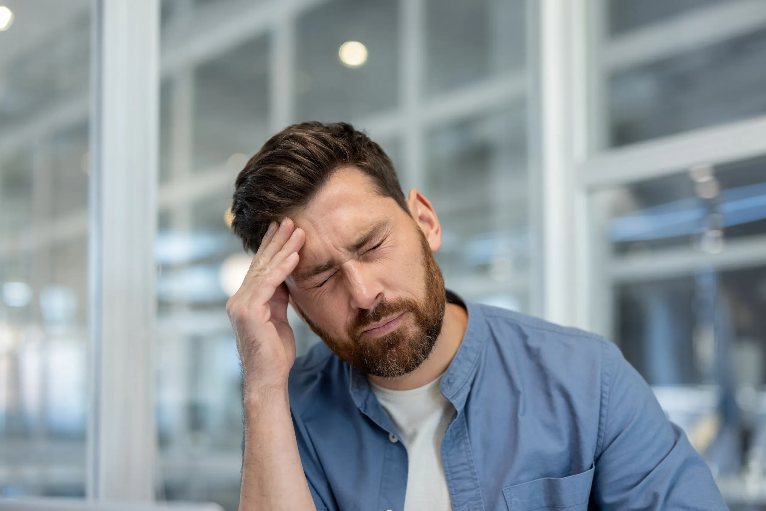 A person easing a cold-weather migraine at home, with same-day care available in Jacksonville, FL.