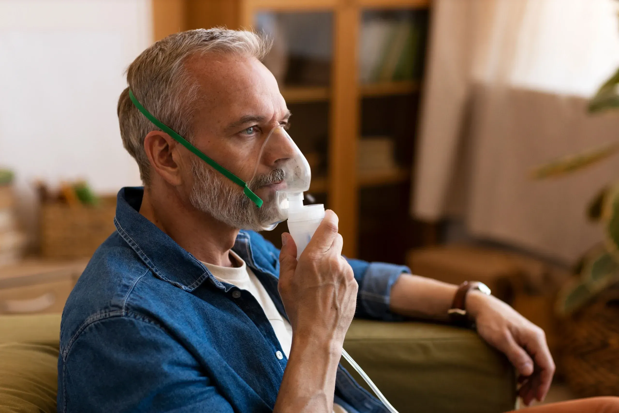 Older adult using an inhaler for COPD symptom relief, supported by care in Jacksonville, FL.