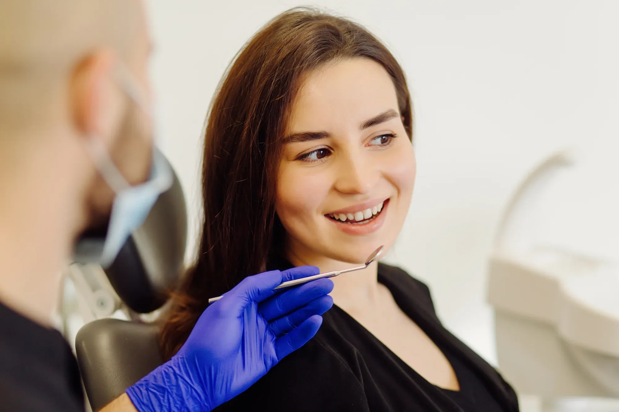 Provider showing cosmetic dentistry options to a patient on a digital display