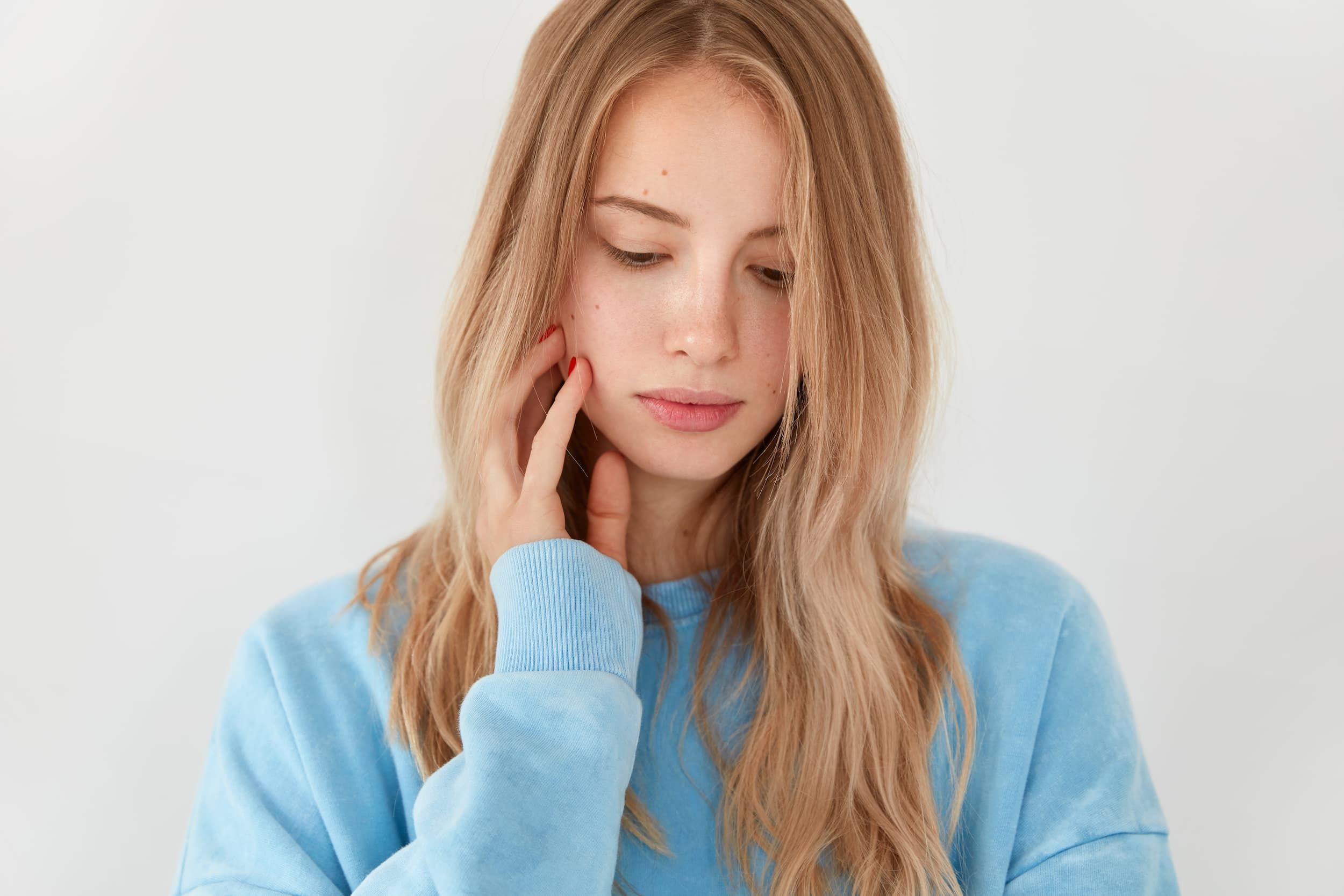Person applying moisturizer to skin affected by psoriasis, primary care in Jacksonville, FL
