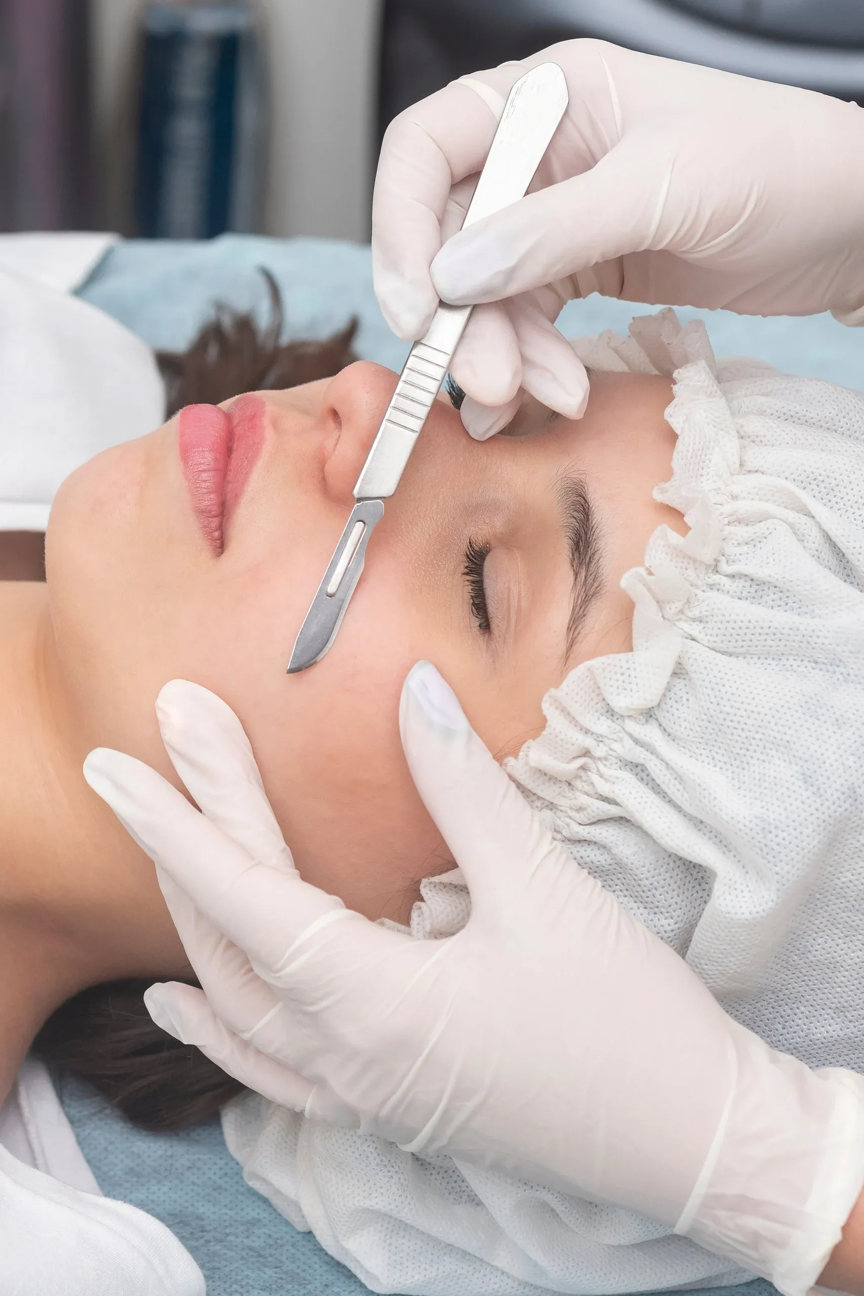 Esthetician performing dermaplaning exfoliation on a client at Heritage Wellness & Med Spa