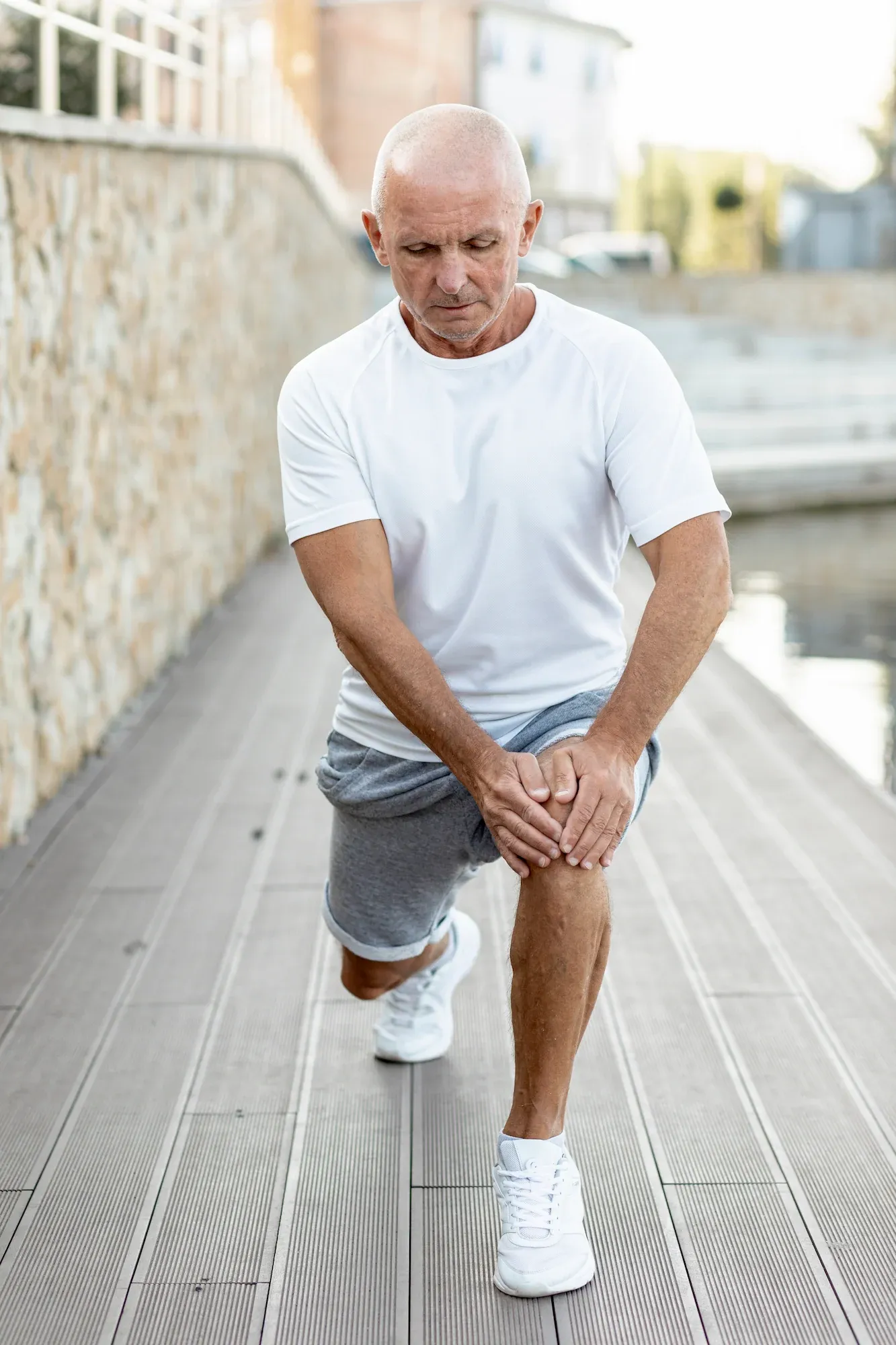 Person experiencing muscle tension discomfort at Roots Chiropractic and Wellness Alma