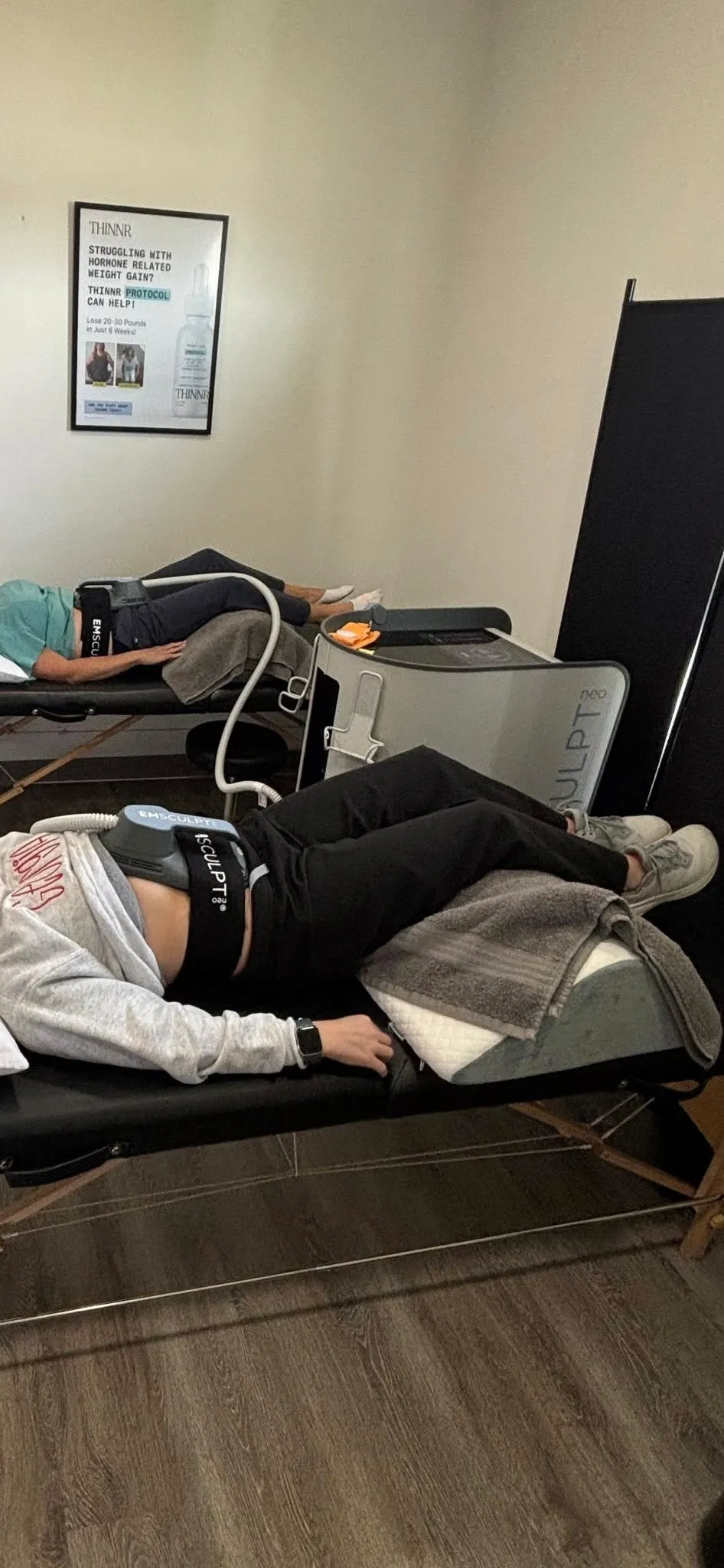 Confident patient portrait after Emsculpt Neo at Roots Chiropractic Alma