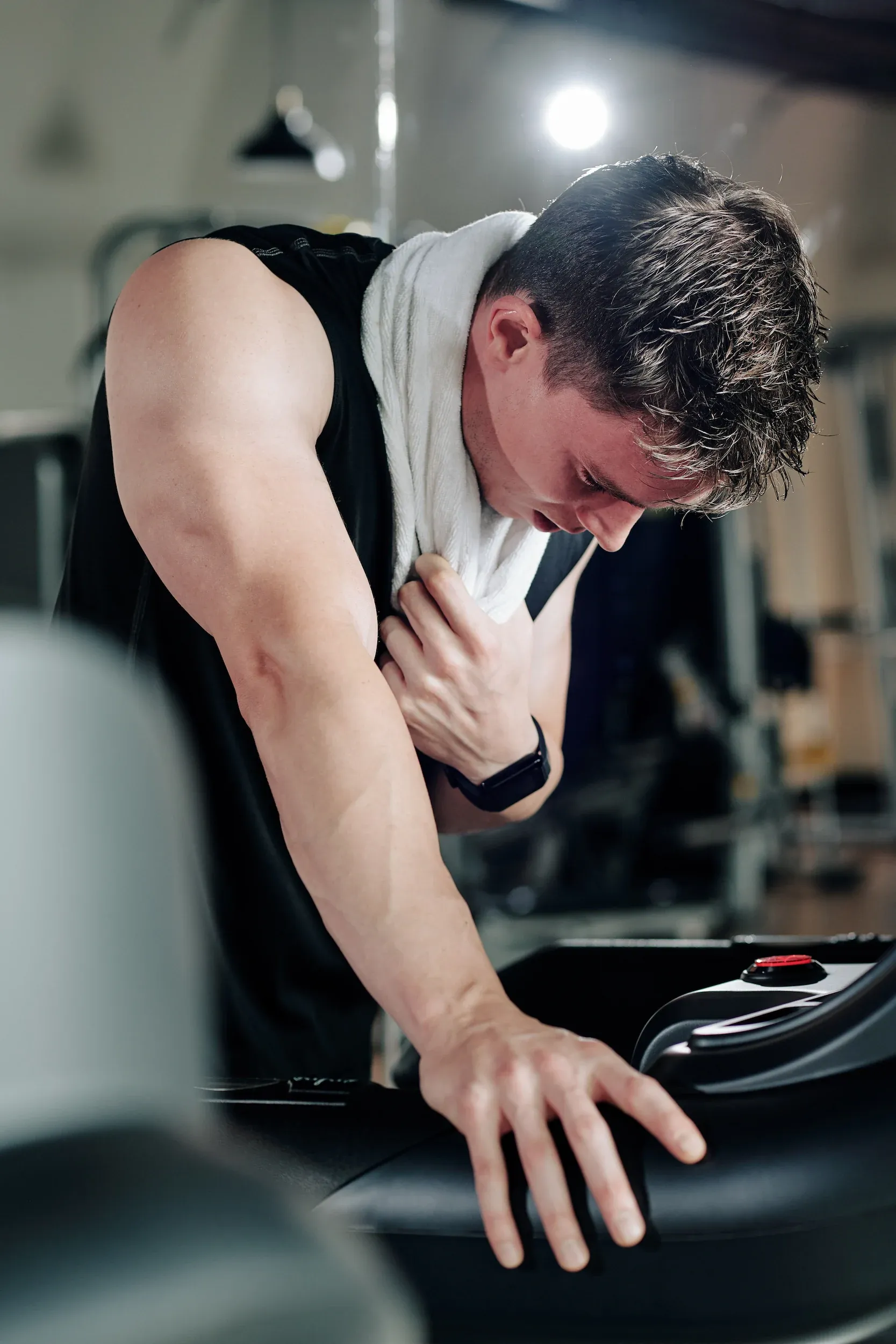 Adult patient examining arm and thigh muscle tone at Resurgent Health Fargo