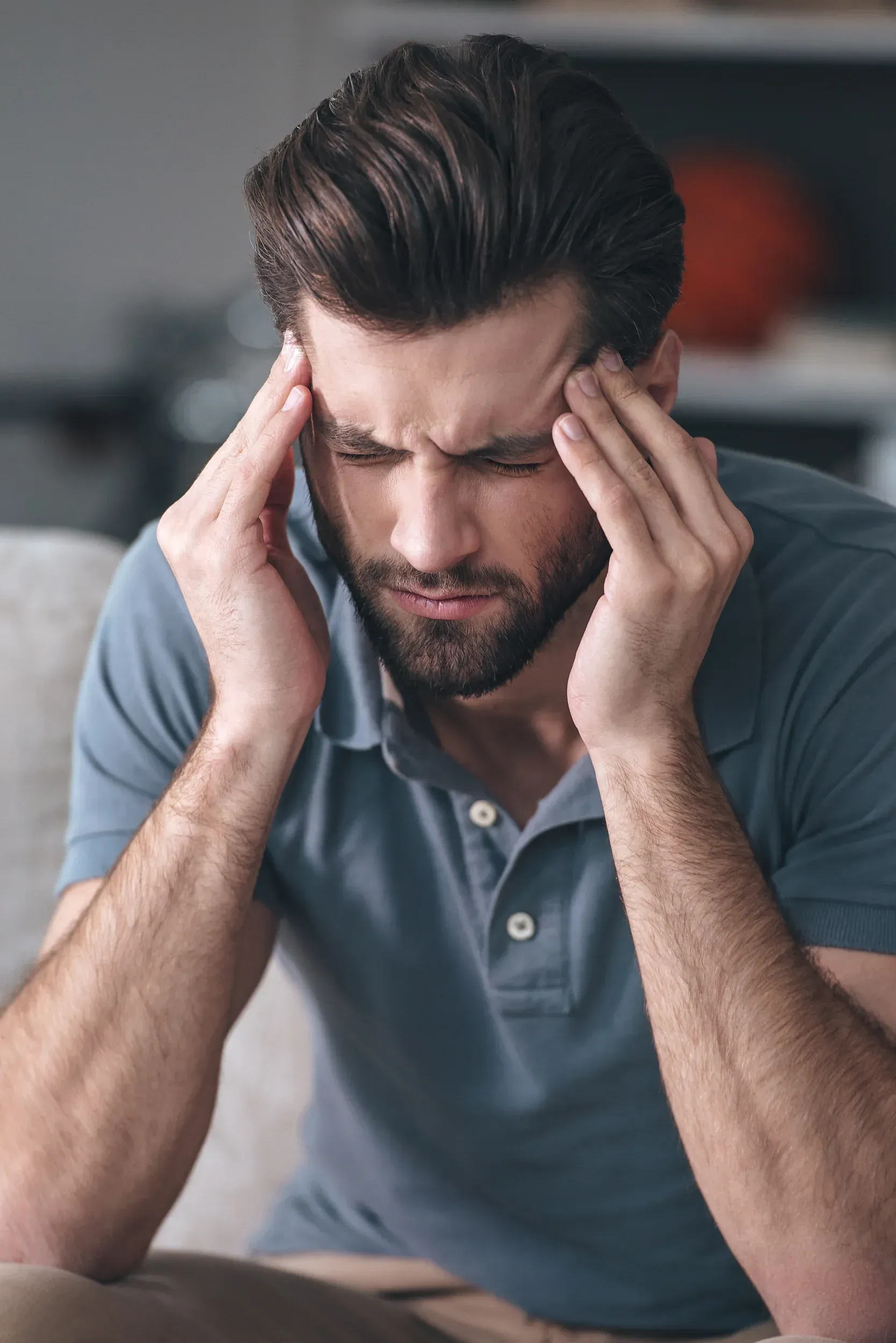 Patient describing headache symptoms during consultation at Spine-Ability