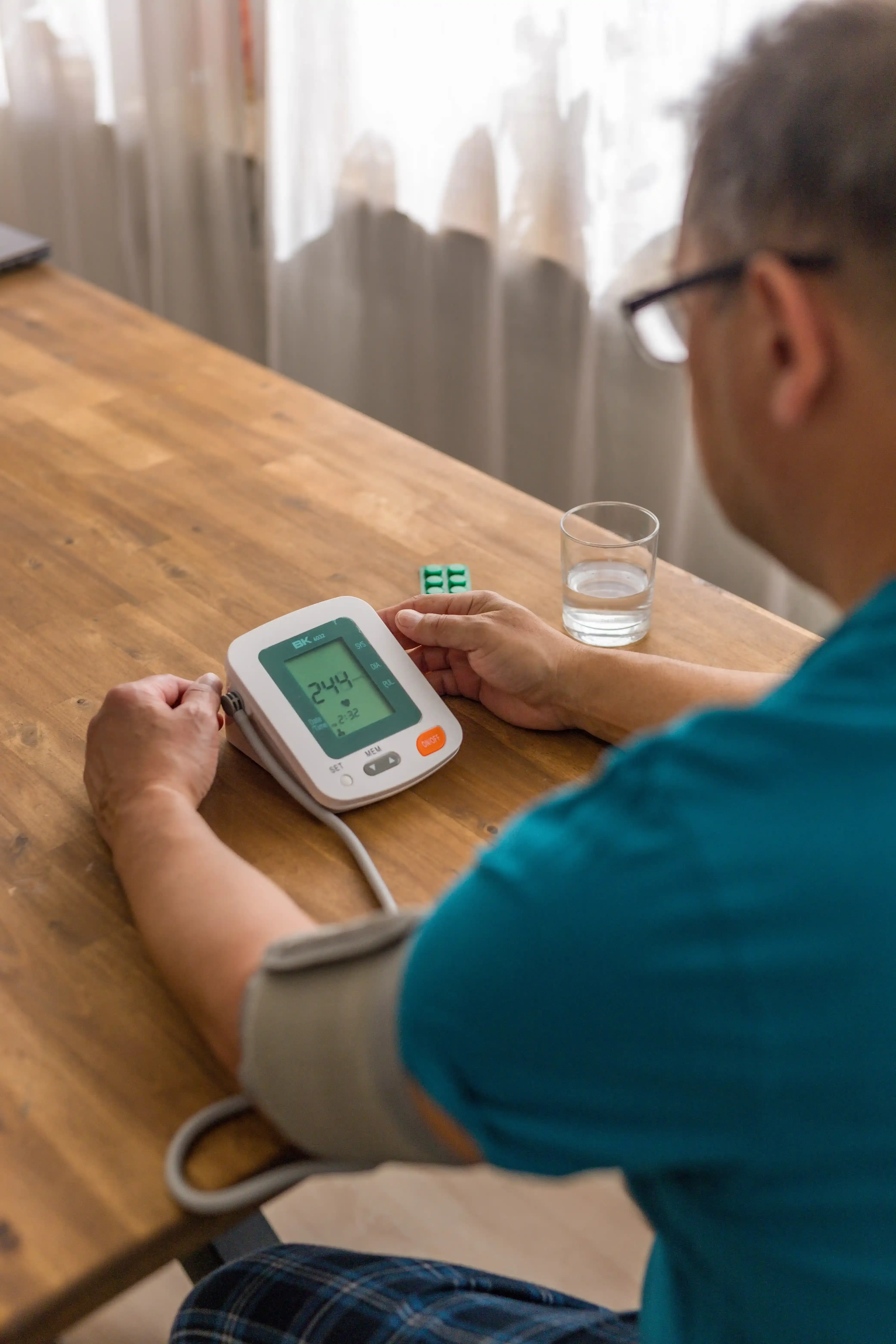 adult patient checking blood pressure concerned about hypertension at Paradise Family Healthcare Venice FL