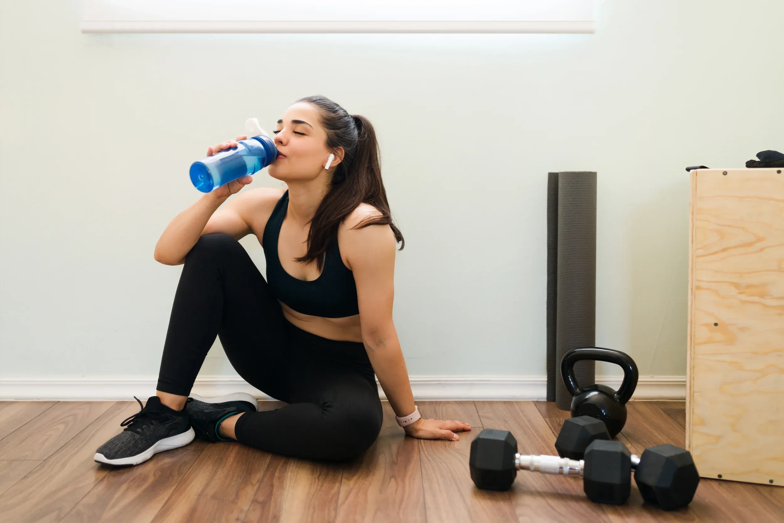 Active patient addressing post-workout recovery at Roots Chiropractic and Wellness Alma