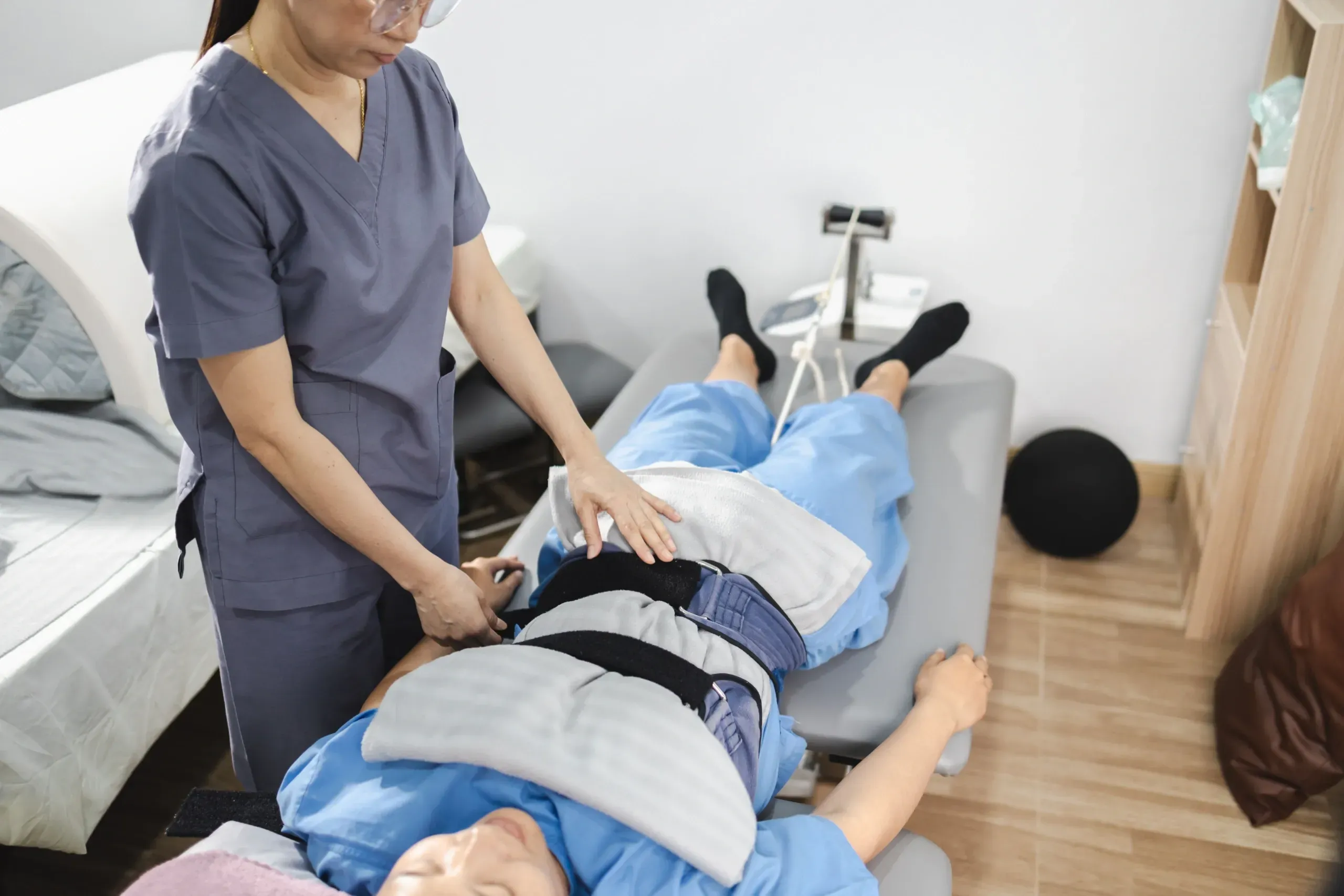 Patient resting on intersegmental traction roller table at Spine-Ability Apollo Beach