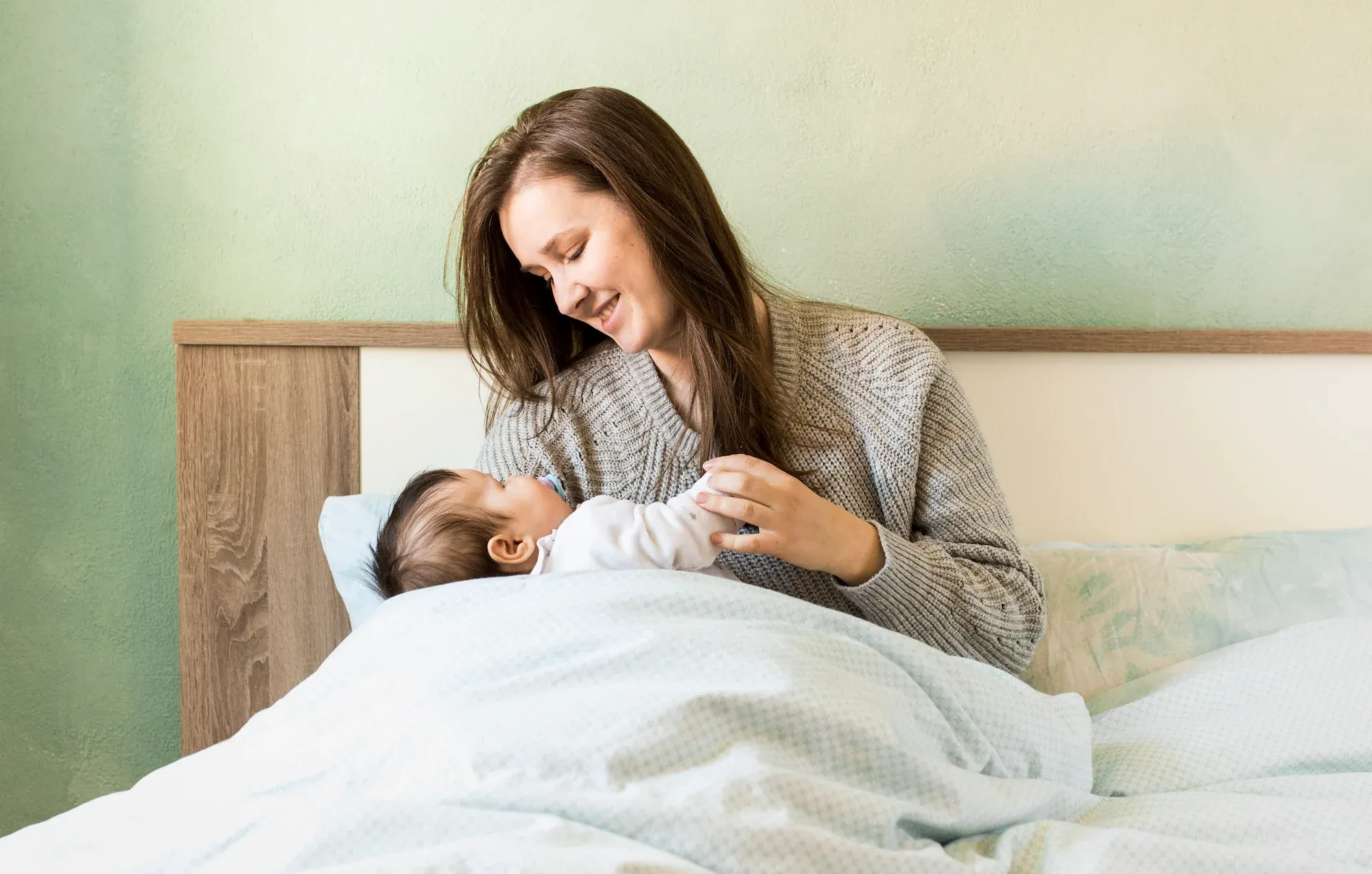 New mother receiving postpartum wellness care at Roots Chiropractic in Alma GA