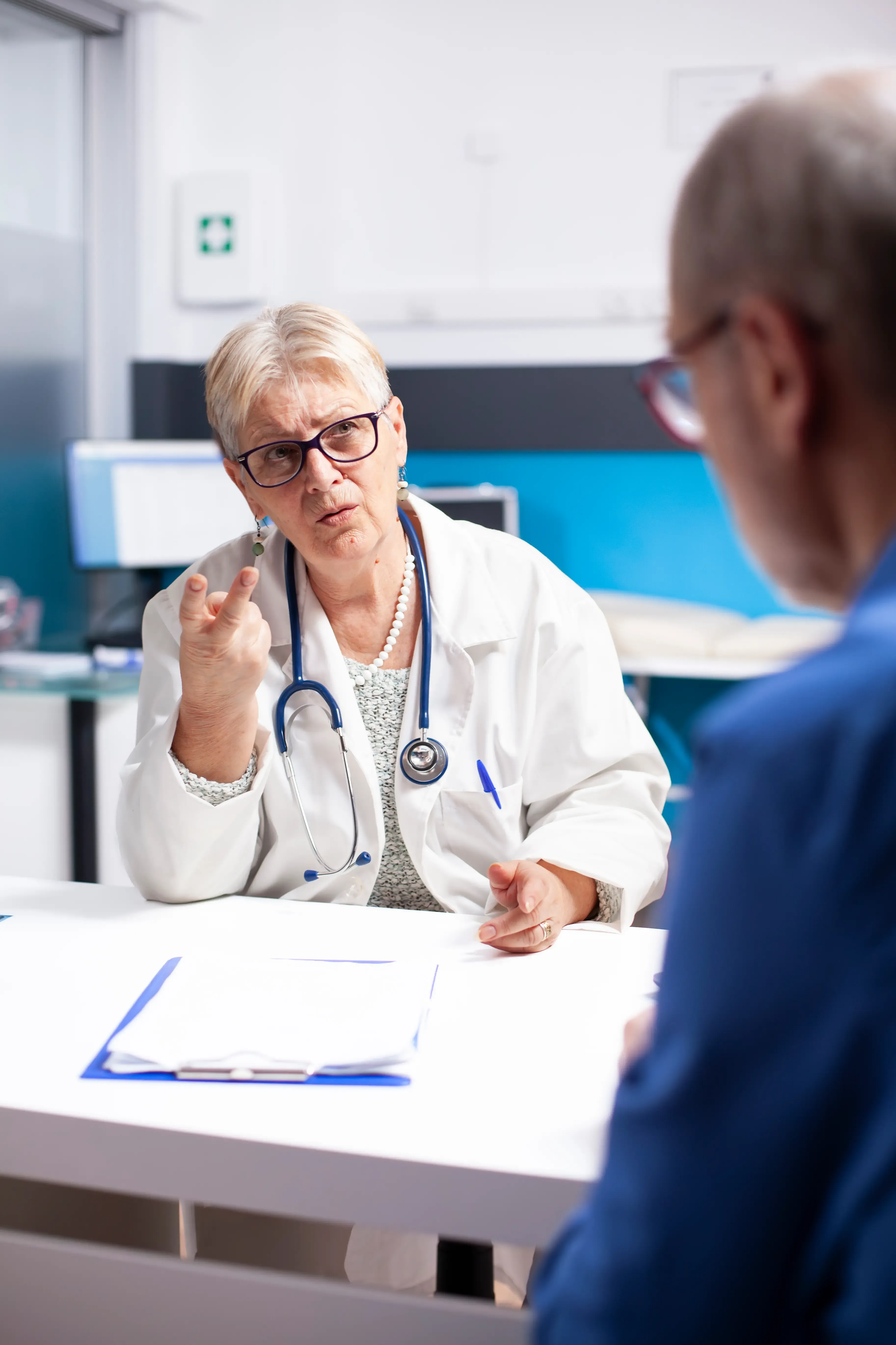 physician reviewing medications with senior patient Venice FL