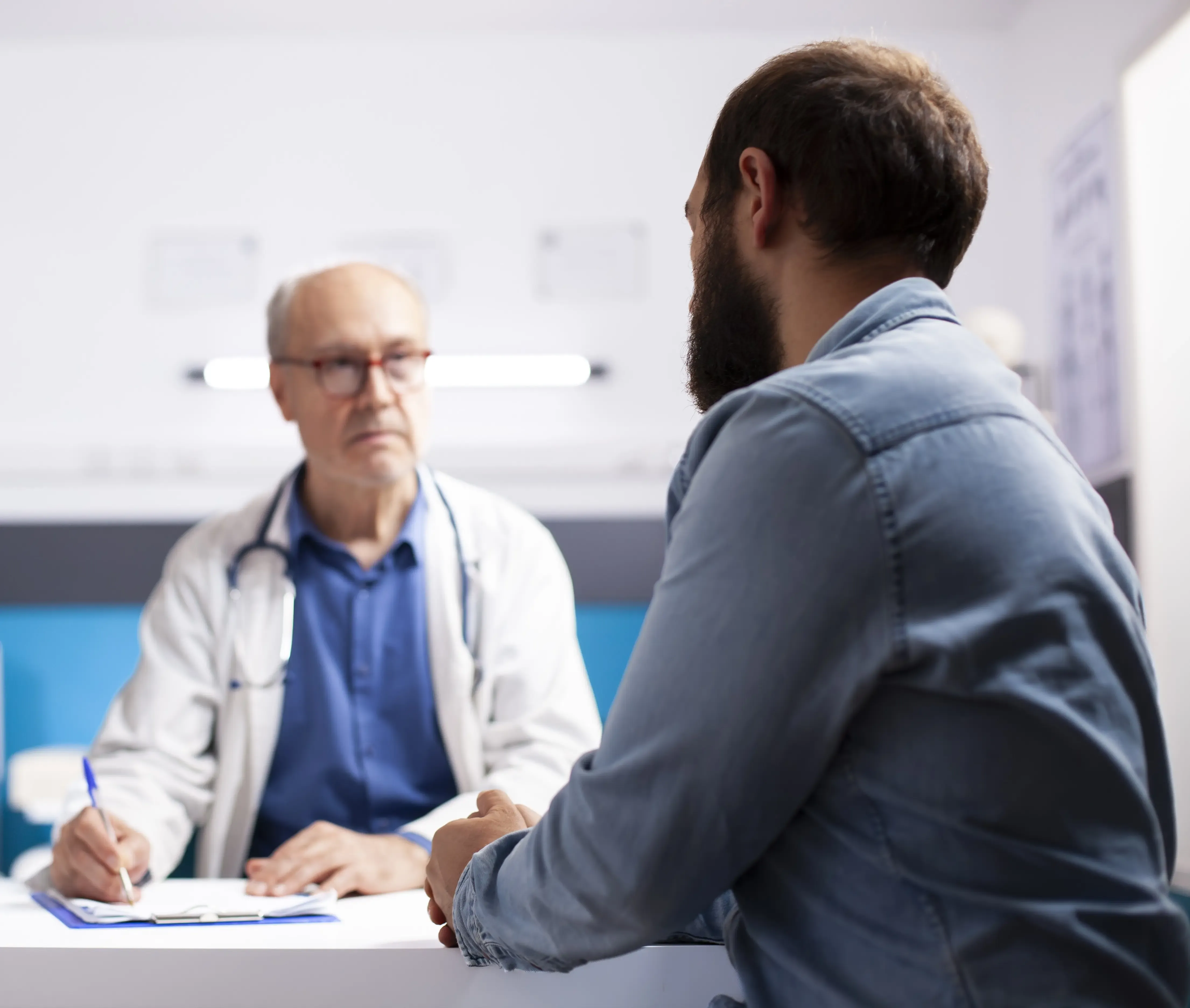 A patient reviewing transparent self-pay pricing with a physician at a primary care clinic in Jacksonville, FL.