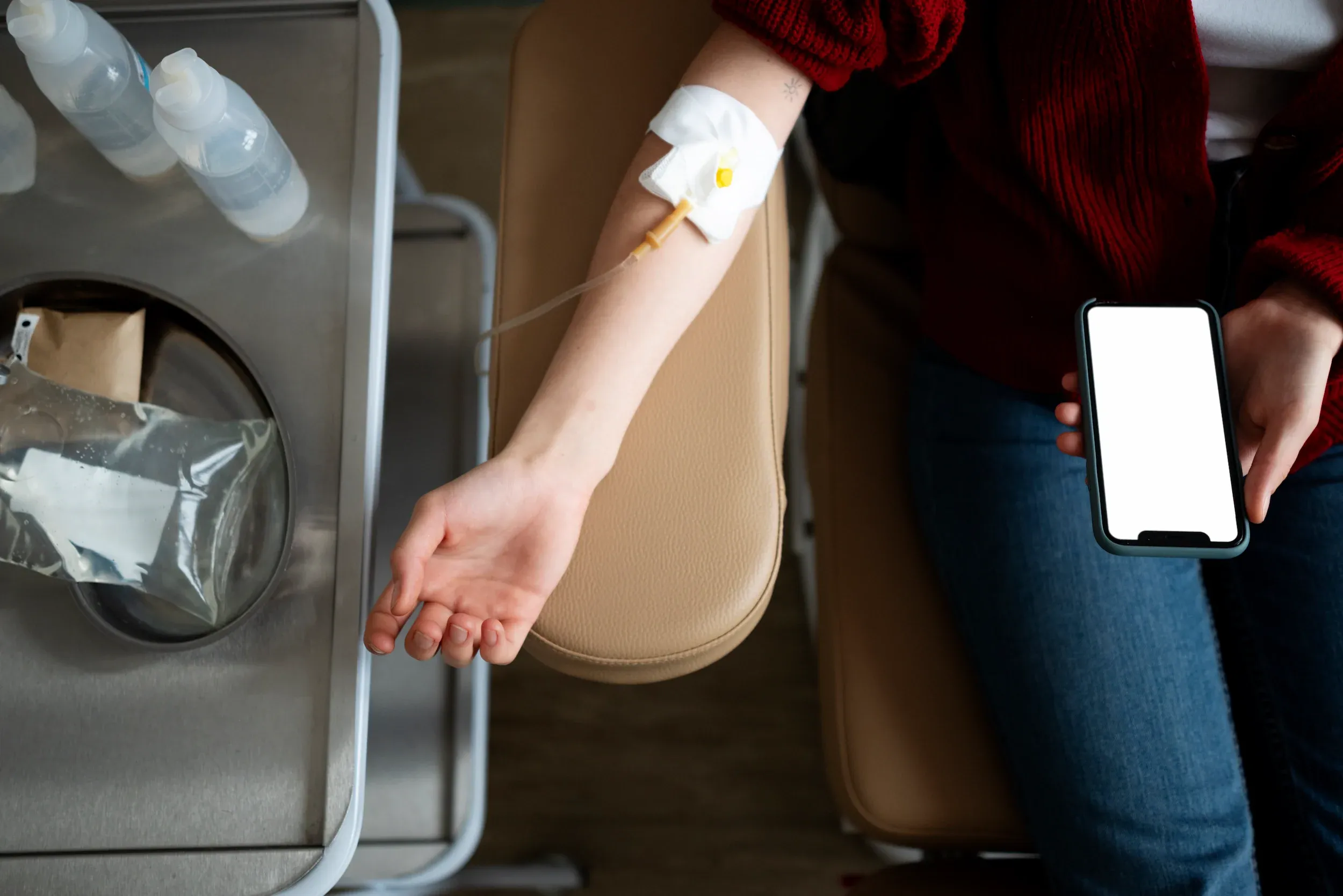 Patient receiving an Olympia Wellness IV drip in a relaxed treatment suite at Pura Vida Med Spa in Fulton, MD