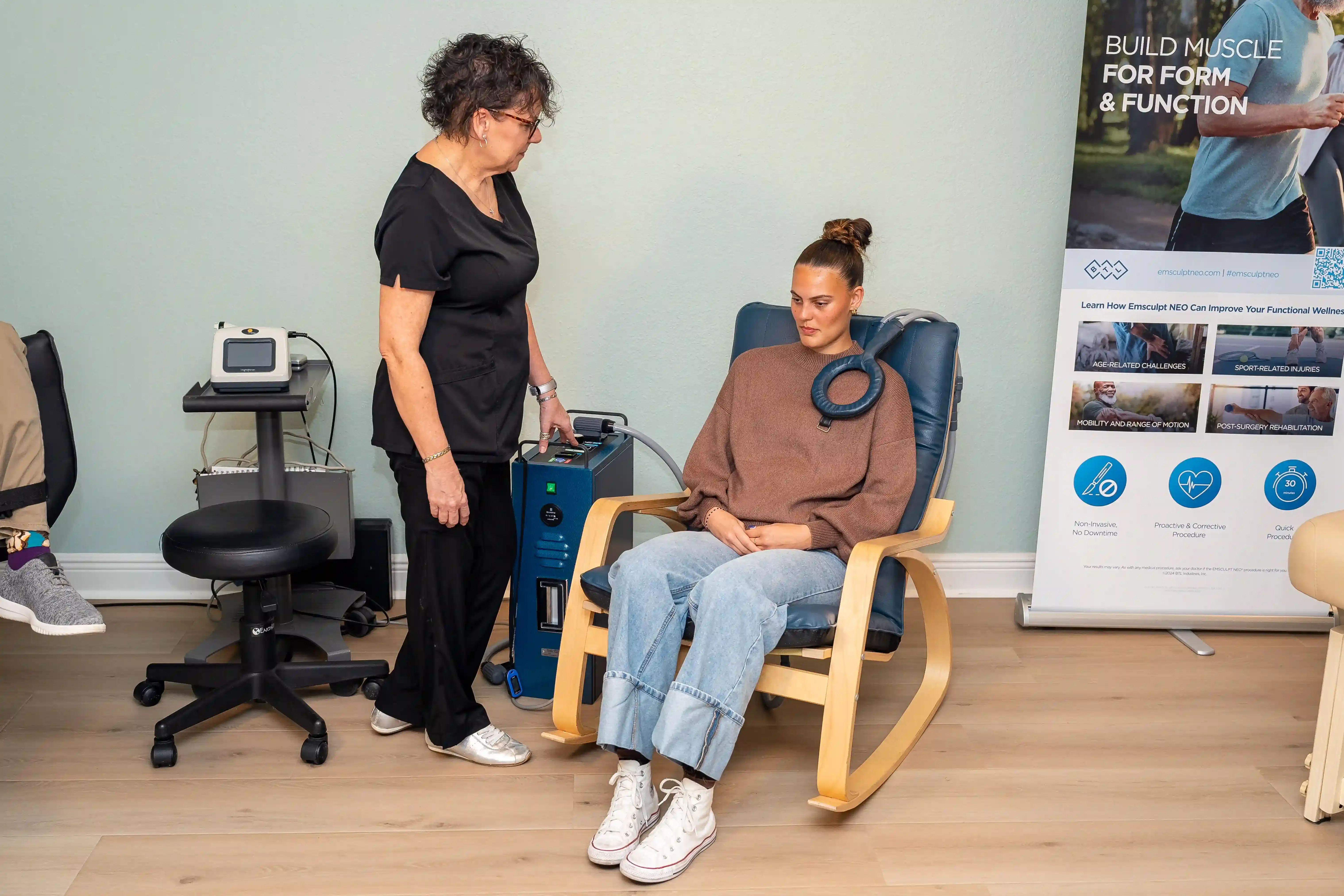 Dr. Korman reviewing PEMF therapy safety protocols with a patient at Arise Integrative Wellness