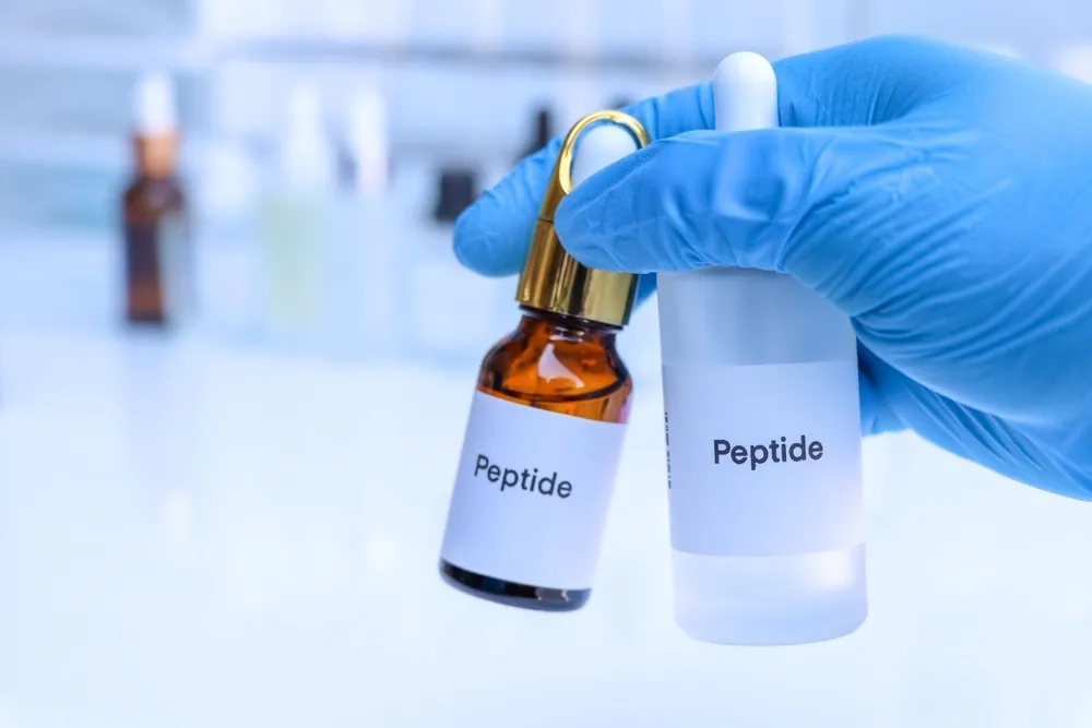 Practitioner using peptide therapy device on client in professional medical spa