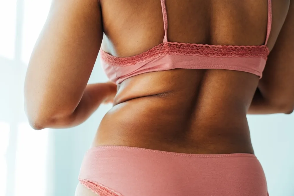 Person concerned about resistant fat areas at Precision Chiropractic