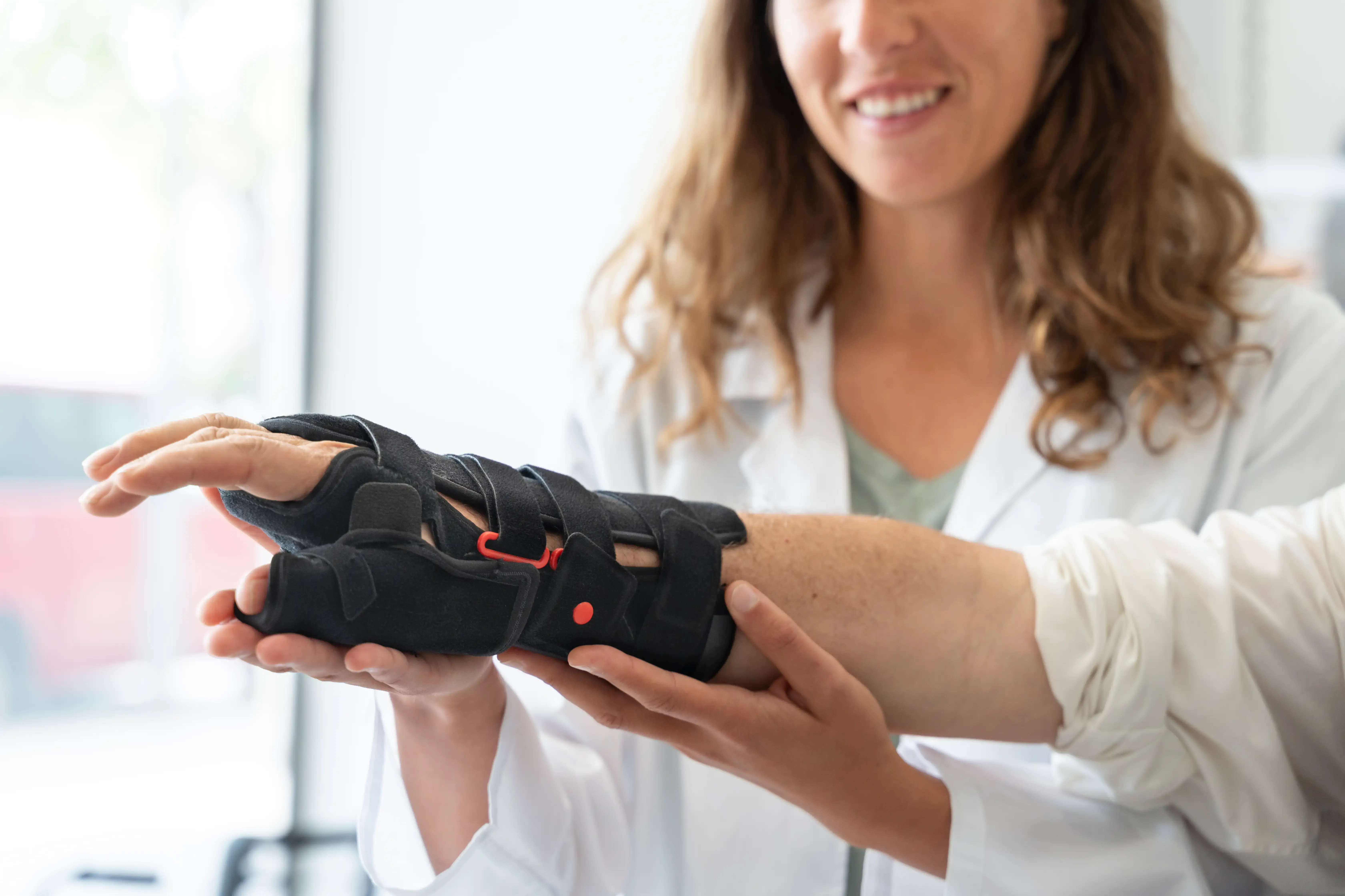 Patient receiving a wrist brace fitting at Emerald Coast Ortho in Fort Walton Beach, FL