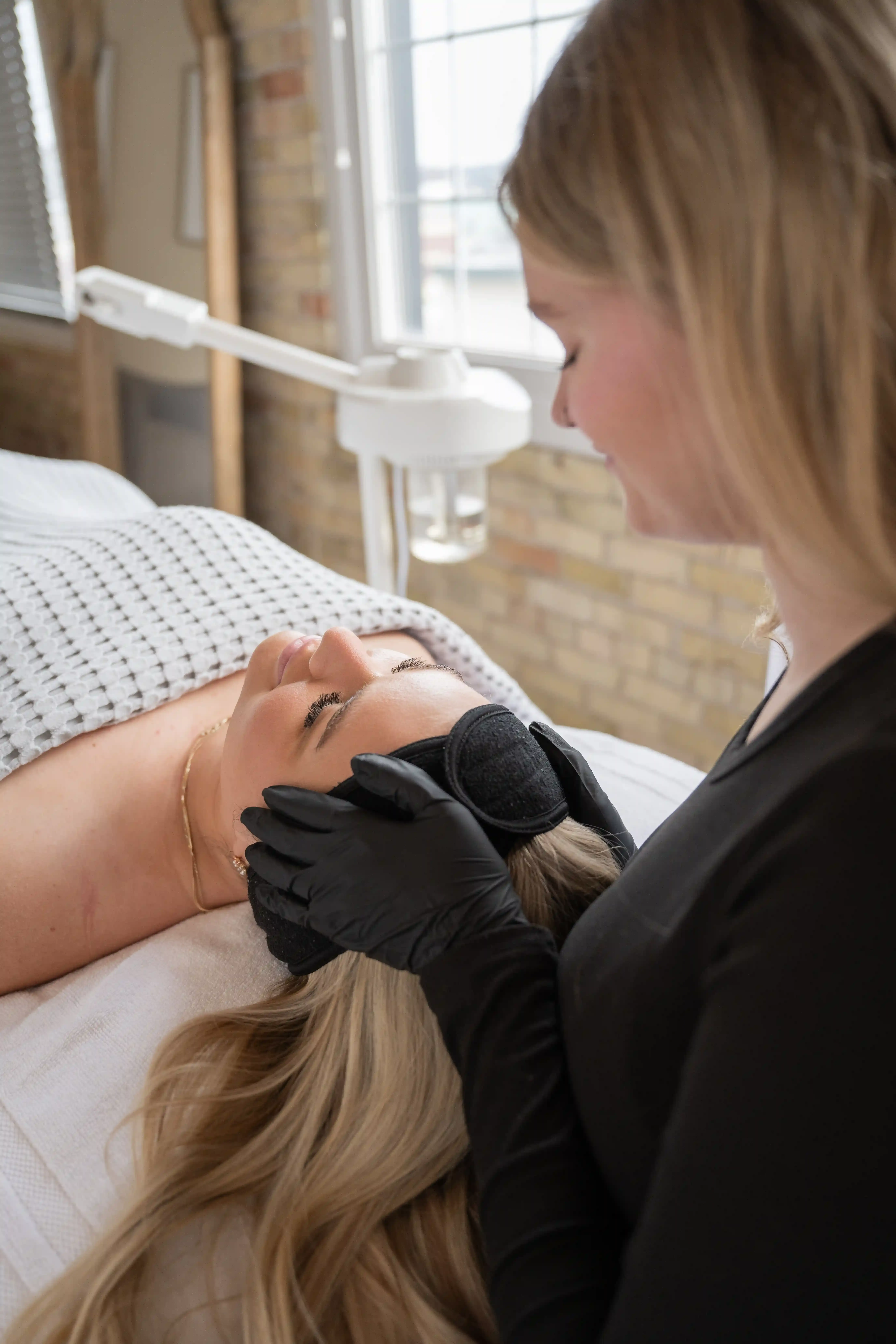 Confident patient with healthy glowing skin after spa facial at Eternal Wellness Traverse City