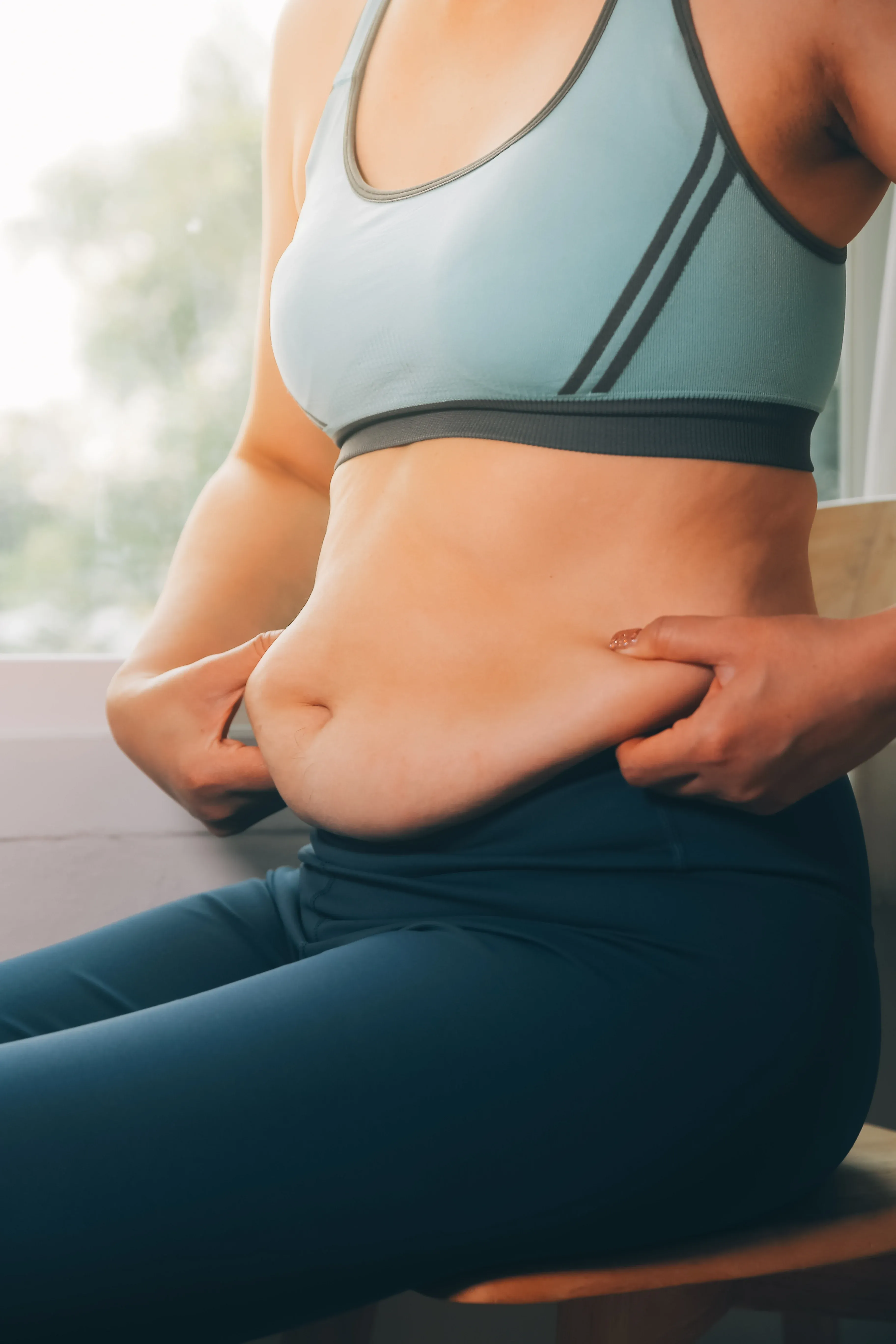 Close-up of midsection showing localized stubborn fat concerns at Hartley Health and Wellness