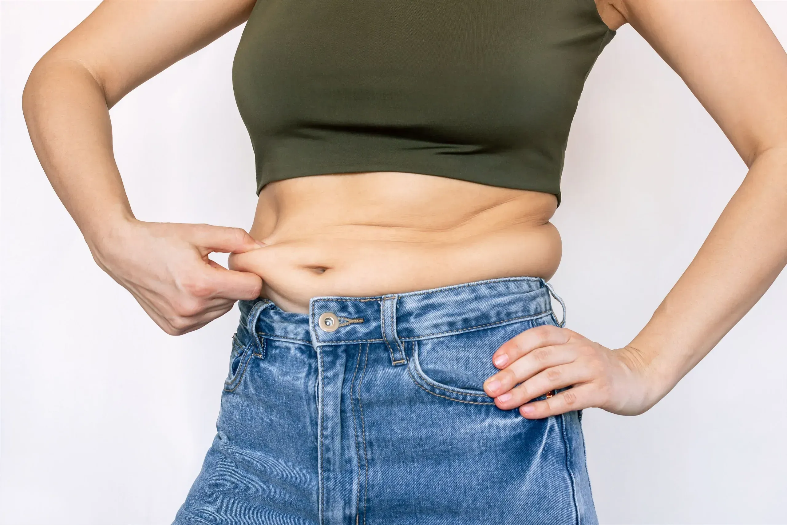 Fit adult reviewing stubborn belly fat and muscle tone goals at Reliance Primary and Urgent Care Jacksonville