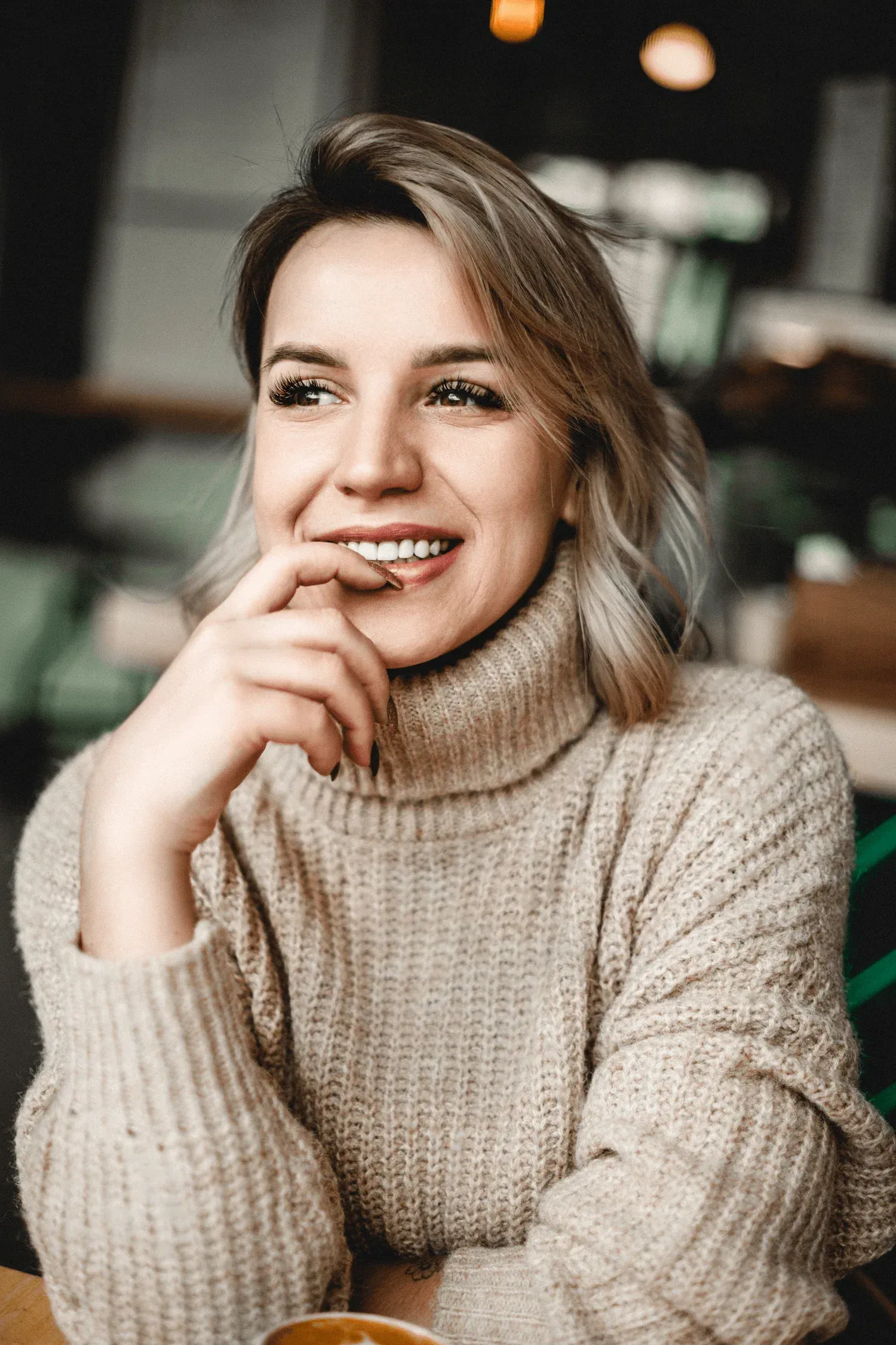 Woman recognizing signs of TMJ disorder at Face and Body by Hartley Medispa Canton